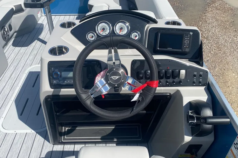 Slide: The Image of 2026 SunCatcher Select 322RC boat dashboard with steering wheel and control panel. - 13