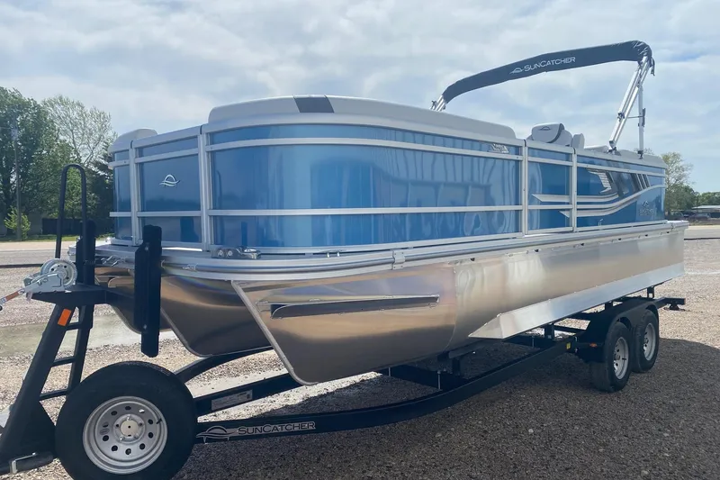 Slide: The Image of 2026 SunCatcher Select 322RC pontoon boat on trailer, featuring sleek blue design. - 3