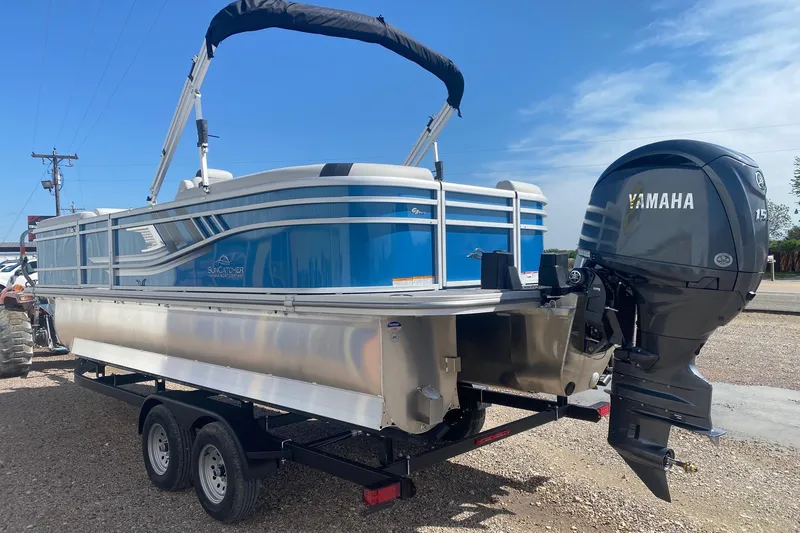 Slide: The Image of 2026 SunCatcher Select 322RC pontoon boat with Yamaha 150 engine on trailer. - 4