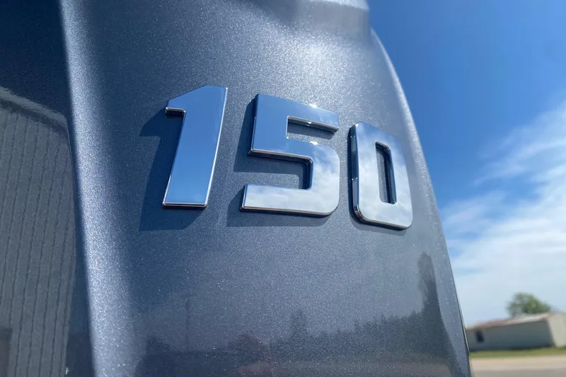 Slide: The Image of Close-up of '150' emblem on 2026 SunCatcher Select 322RC under clear blue sky. - 5