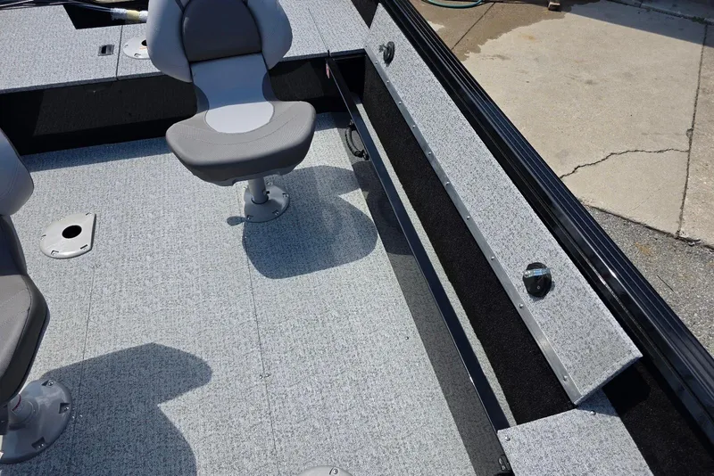 Slide: The Image of 2026 Smoker Craft Pro Angler 165 SC interior with gray seating and carpeted flooring. - 15
