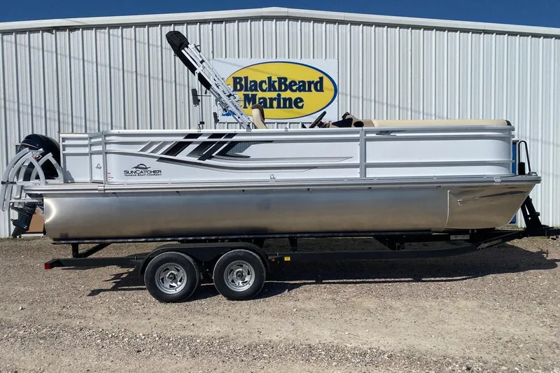 The Image of 2026 SunCatcher Select 22RF pontoon boat on trailer at BlackBeard Marine dealership. - 1
