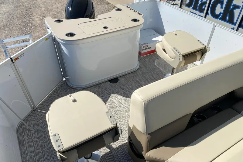 Slide: The Image of Interior of 2026 SunCatcher Select 22RF pontoon boat with beige seating and helm station. - 10