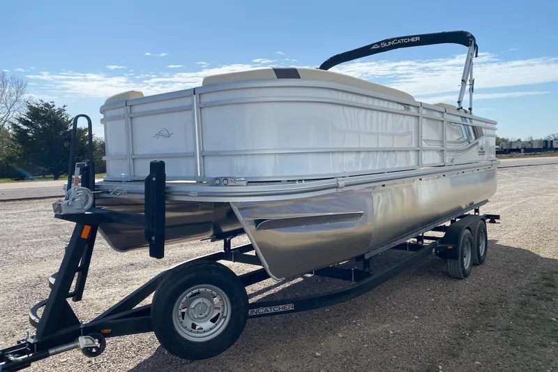 Slide: The Image of 2026 SunCatcher Select 22RF pontoon boat on trailer, parked outdoors under clear sky. - 3