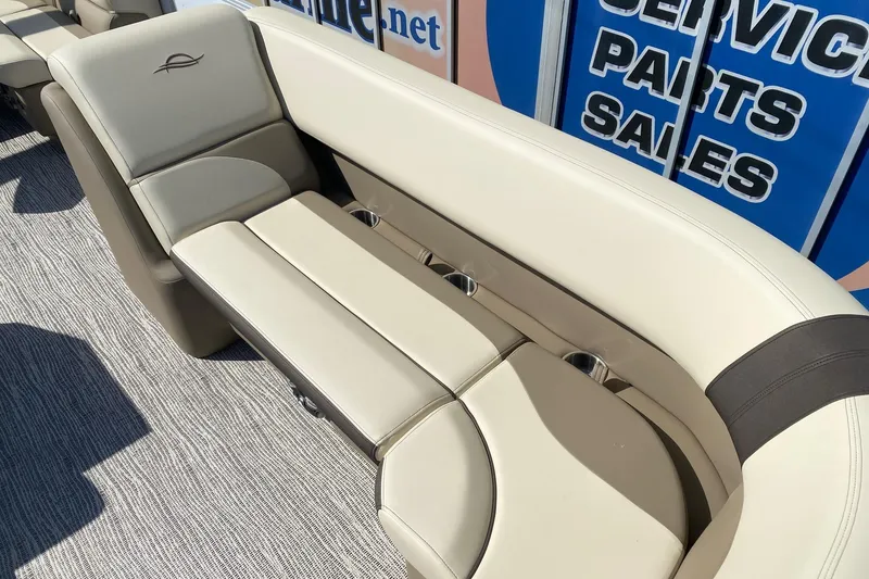Slide: The Image of Luxurious seating on 2026 SunCatcher Select 22RF pontoon boat, featuring beige upholstery and cup holders. - 6