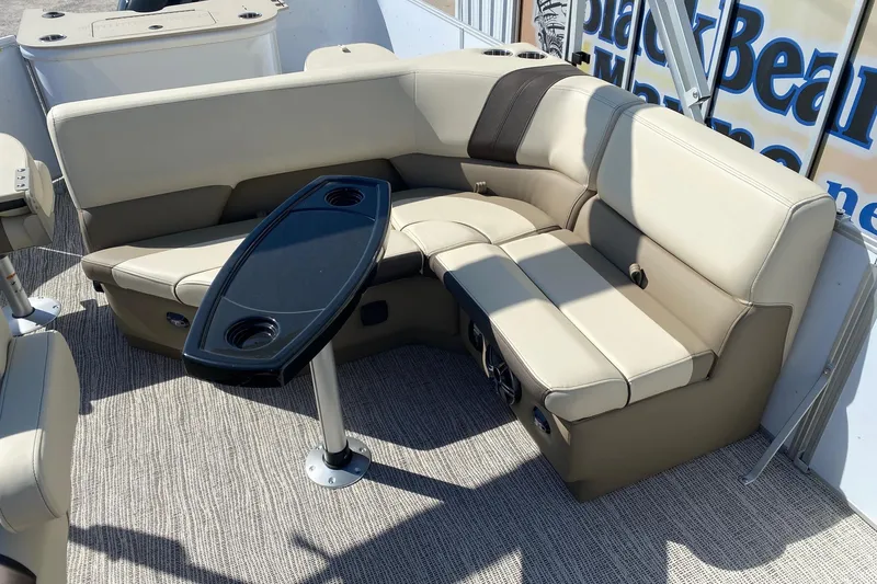 Slide: The Image of Luxurious seating area on 2026 SunCatcher Select 22RF pontoon boat with sleek table design. - 7