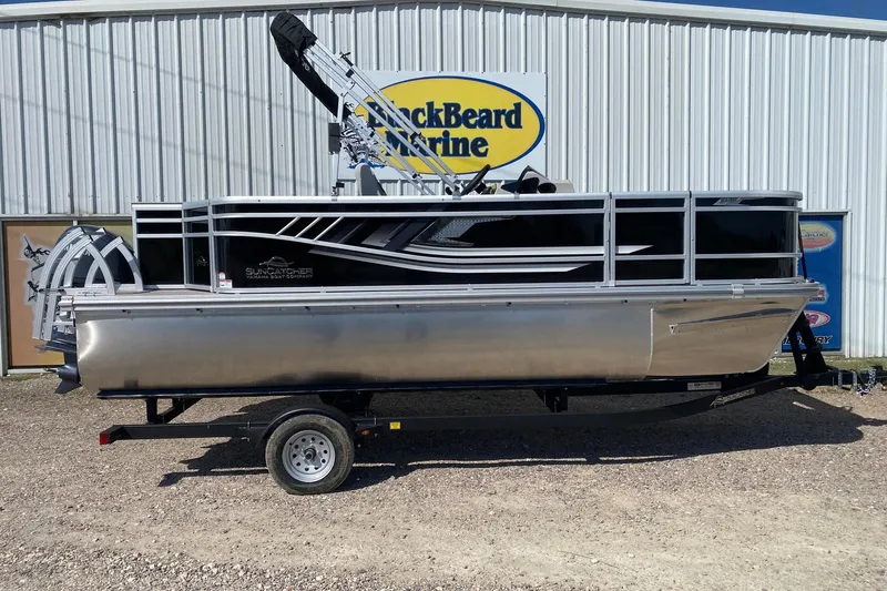 The Image of 2026 SunCatcher Select 18F pontoon boat on trailer, parked outside dealership. - 1
