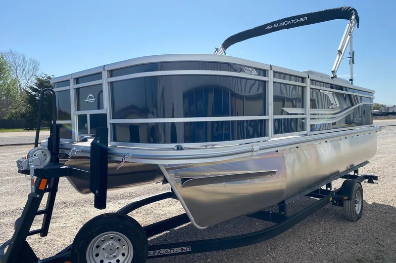 Slide: The Image of 2026 SunCatcher Select 18F pontoon boat on trailer, sunny day, outdoor setting. - 3