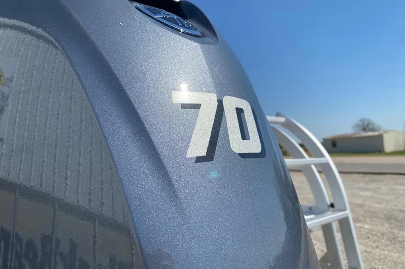Slide: The Image of Close-up of a SunCatcher Select 18F 2026 boat engine with "70" marking. - 5