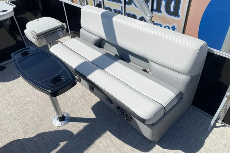 Slide: The Image of Gray seating area on 2026 SunCatcher Select 18F boat with table and cup holders. - 9
