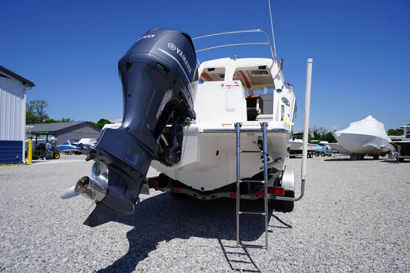 Slide: The Image of 2019 Cutwater C-242 Sport Coupe with Yamaha outboard motor, parked on gravel lot. - 11