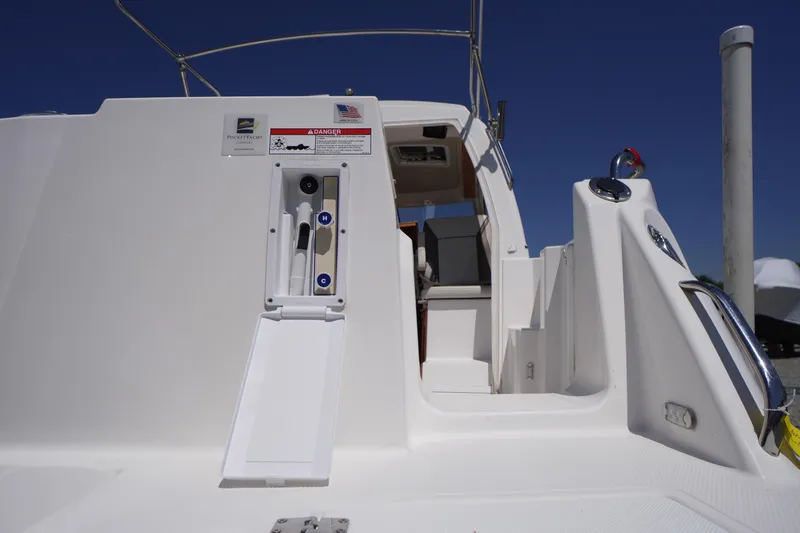 Slide: The Image of 2019 Cutwater C-242 Sport Coupe boat deck with open hatch and seating area. - 13