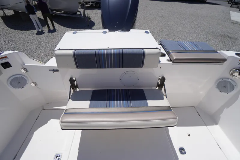 Slide: The Image of 2019 Cutwater C-242 Sport Coupe boat interior with striped seating and speakers. - 20