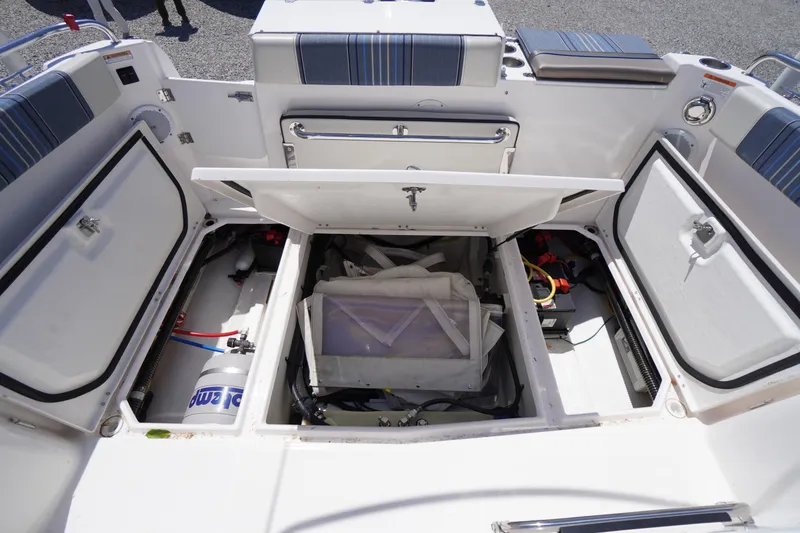 Slide: The Image of 2019 Cutwater C-242 Sport Coupe boat storage compartments open, showcasing interior equipment and seating. - 21