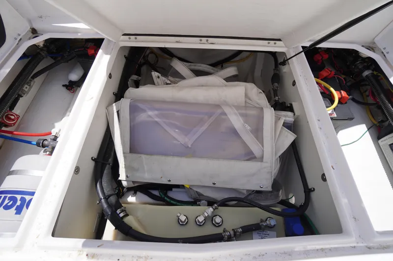 Slide: The Image of 2019 Cutwater C-242 Sport Coupe engine compartment with wiring and storage components. - 22