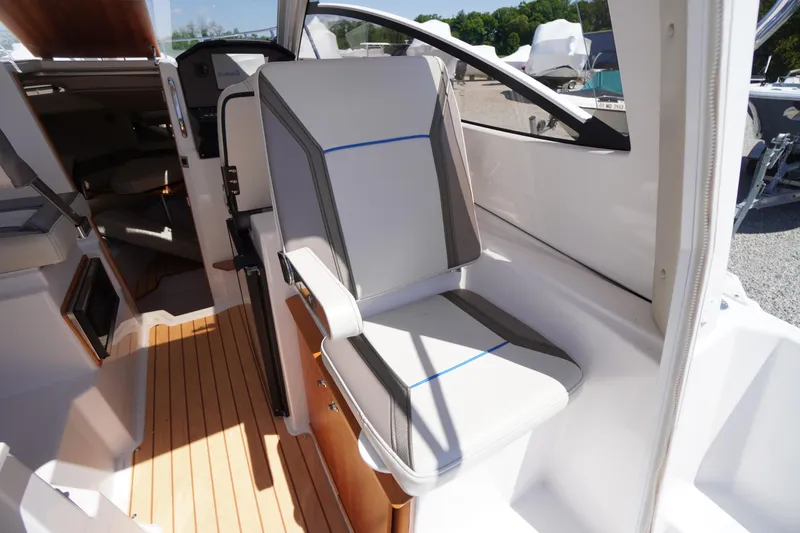 Slide: The Image of 2019 Cutwater C-242 Sport Coupe interior with modern seating and wooden flooring. - 25