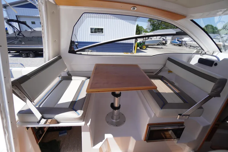 Slide: The Image of Interior of 2019 Cutwater C-242 Sport Coupe with seating and wooden table. - 26