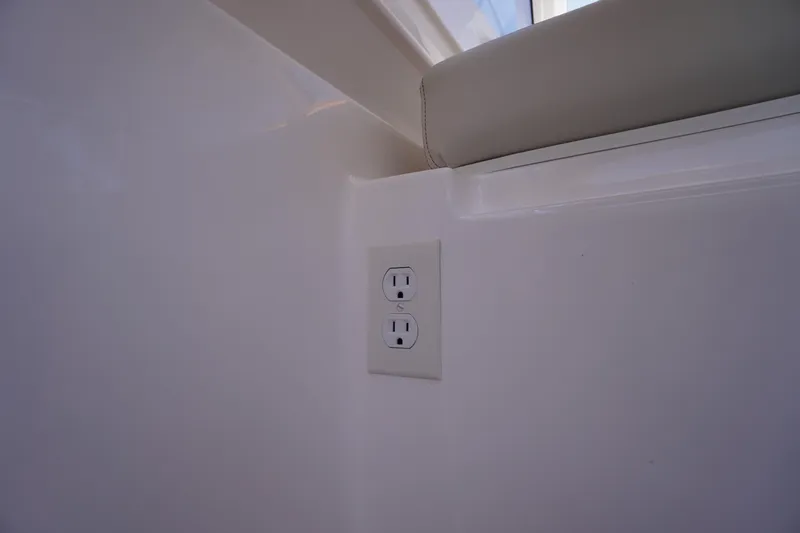 Slide: The Image of 2019 Cutwater C-242 Sport Coupe interior with a wall outlet and cushioned ledge. - 27