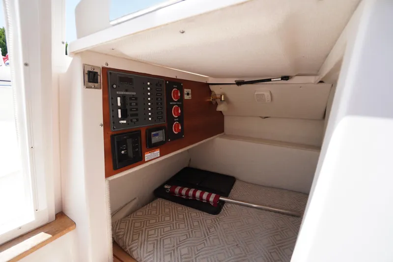 Slide: The Image of 2019 Cutwater C-242 Sport Coupe cabin interior with control panel and storage area. - 28