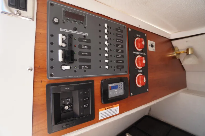 Slide: The Image of Control panel of a 2019 Cutwater C-242 Sport Coupe boat, featuring various switches and dials. - 29