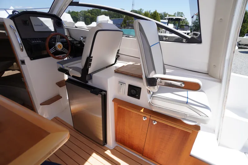 Slide: The Image of Interior of 2019 Cutwater C-242 Sport Coupe with helm, seating, and compact fridge. - 32