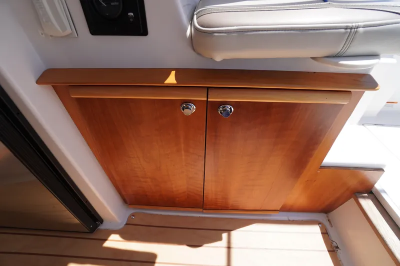 Slide: The Image of Wooden cabinet doors inside a 2019 Cutwater C-242 Sport Coupe boat interior. - 34