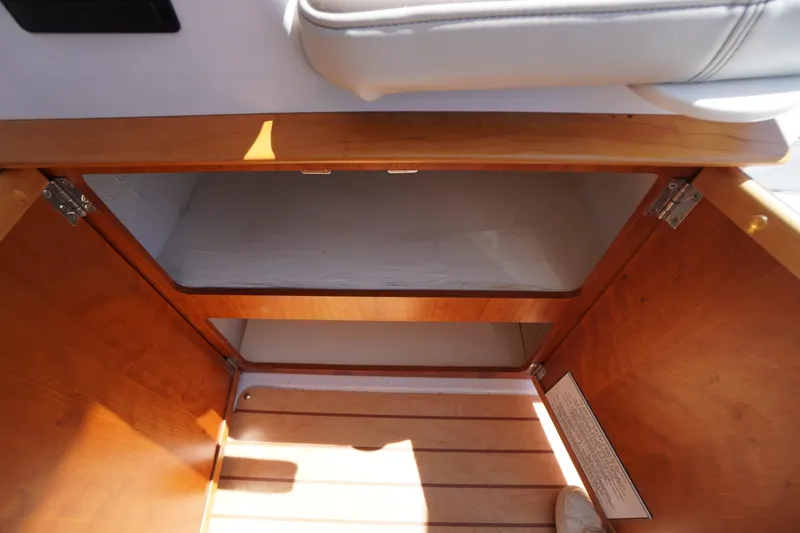 Slide: The Image of 2019 Cutwater C-242 Sport Coupe interior storage compartment with wooden finish. - 35