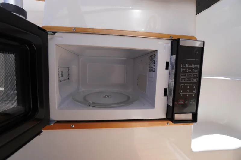 Slide: The Image of Microwave inside 2019 Cutwater C-242 Sport Coupe, featuring digital controls and turntable. - 40