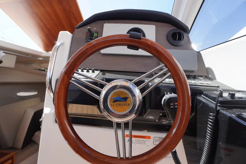 Slide: The Image of Steering wheel of 2019 Cutwater C-242 Sport Coupe boat, featuring wood finish and control panel. - 43