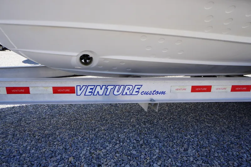Slide: The Image of Trailer for 2019 Cutwater C-242 Sport Coupe, labeled "Venture Custom," on gravel surface. - 5