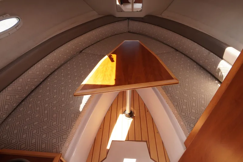 Slide: The Image of 2019 Cutwater C-242 Sport Coupe interior with wooden table and patterned seating. - 53
