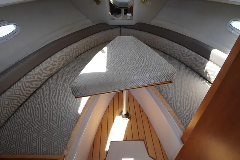 Slide: The Image of 2019 Cutwater C-242 Sport Coupe interior with patterned cushions and wooden flooring. - 54