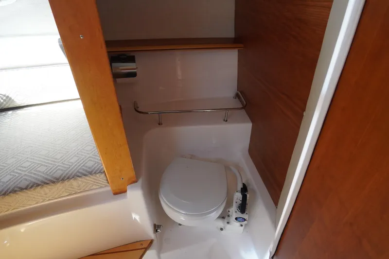 Slide: The Image of 2019 Cutwater C-242 Sport Coupe boat interior with compact marine toilet. - 55