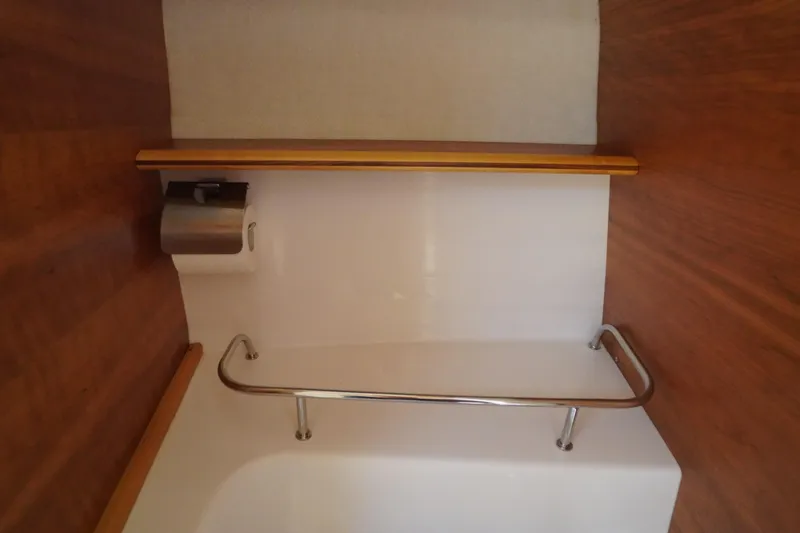 Slide: The Image of 2019 Cutwater C-242 Sport Coupe bathroom with wooden accents and stainless steel fixtures. - 57