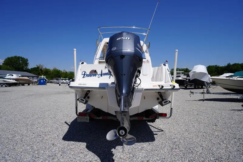 Slide: The Image of 2019 Cutwater C-242 Sport Coupe boat with outboard motor in a gravel lot. - 7