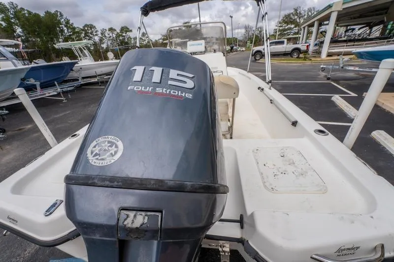 Slide: The Image of 2005 Century 1902 Inshore boat with 115 four-stroke engine in a parking lot. - 14