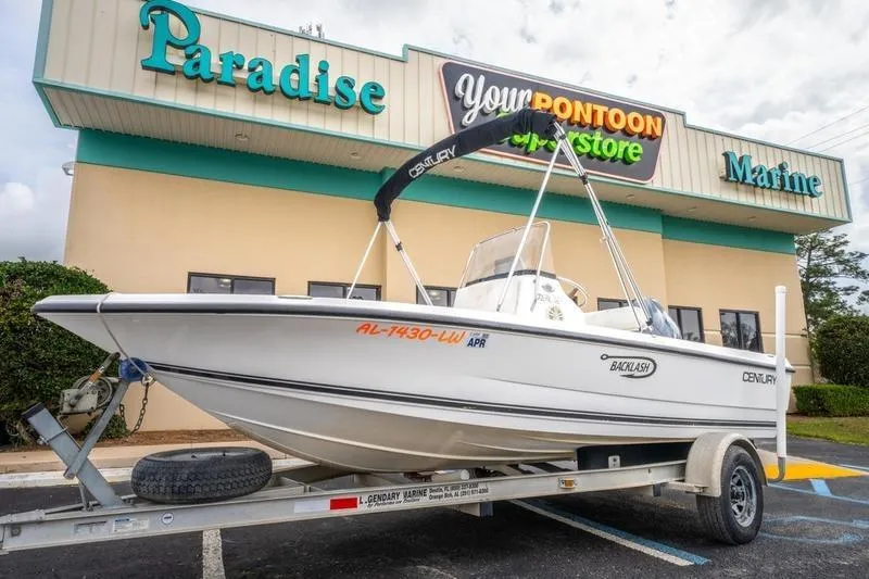 Slide: The Image of 2005 Century 1902 Inshore boat on trailer outside Paradise Marine store. - 4