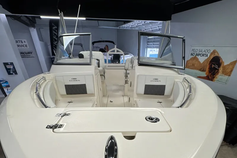 Slide: The Image of 2024 Cobia 220 Dual Console boat interior view in showroom. - 11