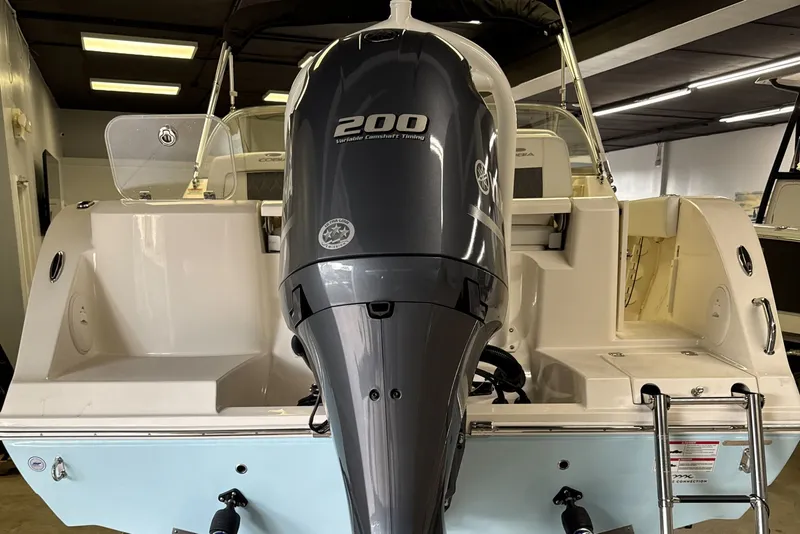 Slide: The Image of 2024 Cobia 220 Dual Console with 200 HP outboard motor. - 6