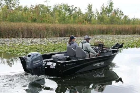 Slide: The Image of Manufacturer Provided Image: 2026 Smoker Craft Pro Angler 165 SC boat navigating a lush, green waterway. - 25