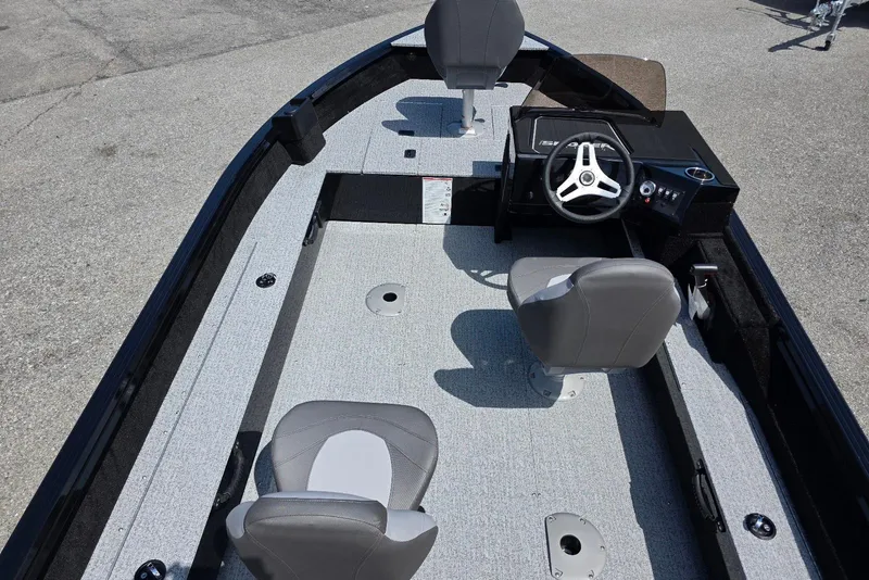 Slide: The Image of 2026 Smoker Craft Pro Angler 165 SC boat interior with steering console and seating. - 8