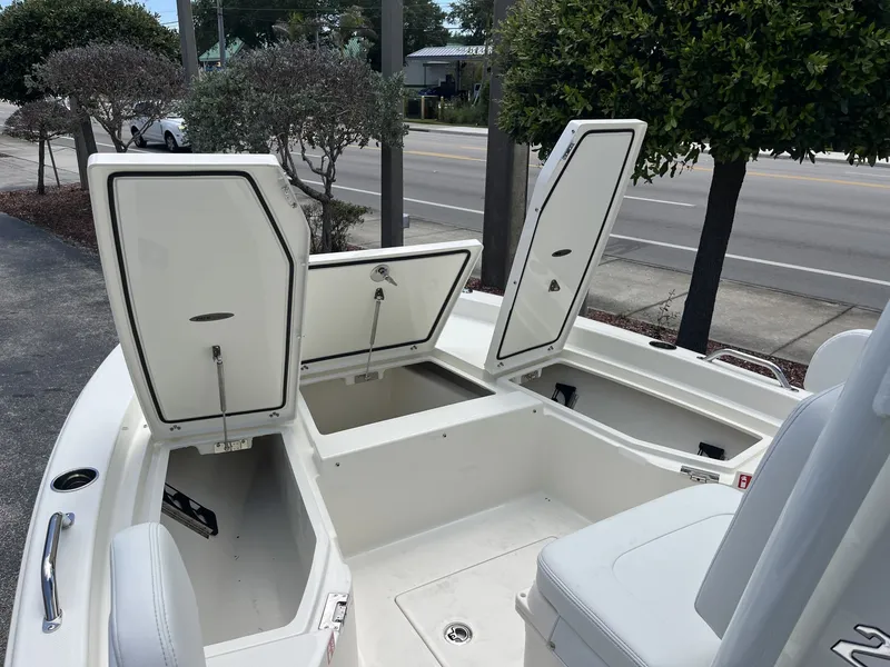 Slide: The Image of Pathfinder 2200 TRS 2026 with open storage compartments in a parking area. - 16