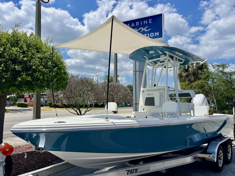 Slide: The Image of 2026 Pathfinder 2200 TRS boat on trailer under sunshade. - 29