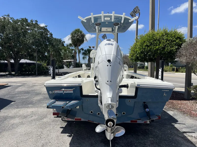 Slide: The Image of 2026 Pathfinder 2200 TRS boat with outboard motor, parked outdoors. - 5