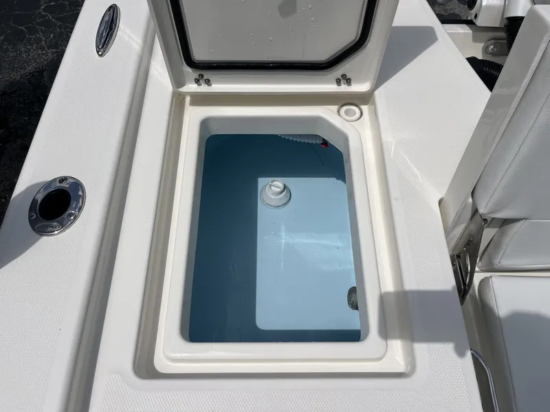 Slide: The Image of Pathfinder 2200 TRS 2026 boat hatch with open storage compartment. - 20