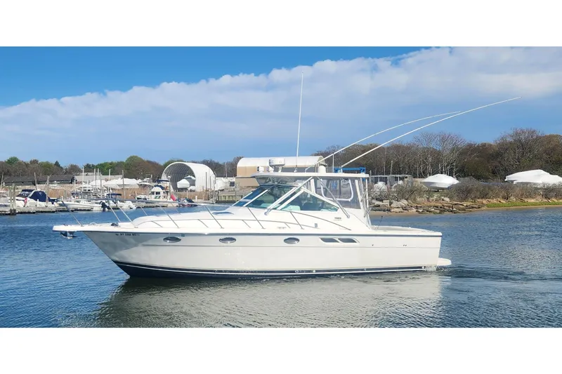 The Image of 2003 Tiara Yachts 3100 Open LE cruising on a calm waterway under a clear sky. - 0