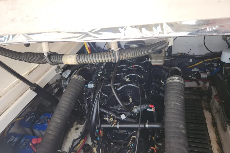 Slide: The Image of Engine compartment of a 2003 Tiara Yachts 3100 Open LE, showcasing mechanical components and wiring. - 10