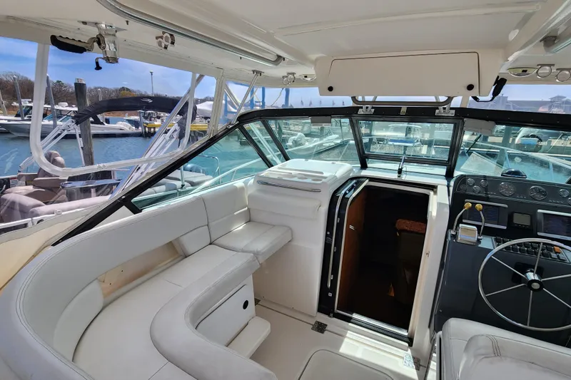 Slide: The Image of 2003 Tiara Yachts 3100 Open LE interior with helm, seating, and cabin entrance. - 18