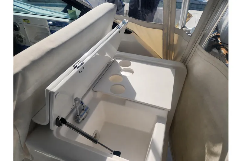 Slide: The Image of 2003 Tiara Yachts 3100 Open LE boat sink and counter with cup holders. - 19