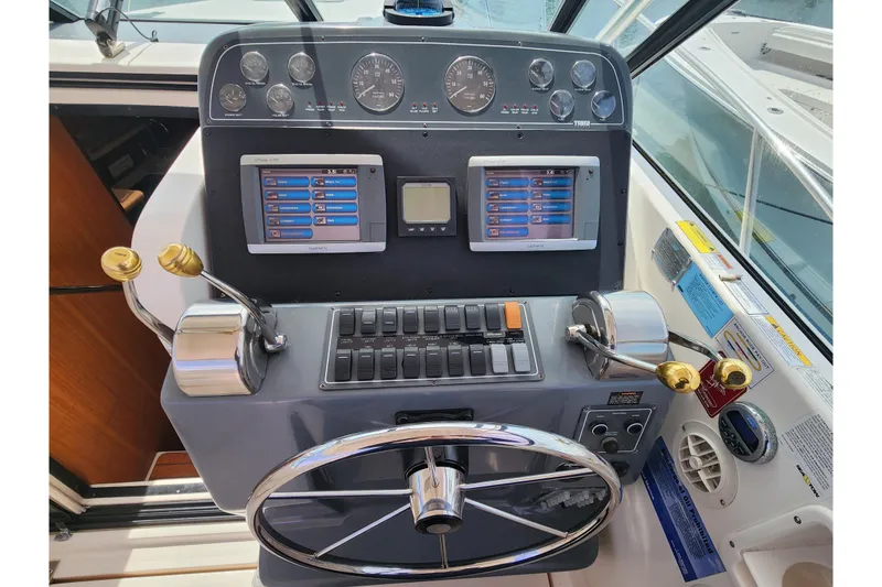 Slide: The Image of Control panel of a 2003 Tiara Yachts 3100 Open LE, featuring gauges and navigation equipment. - 22